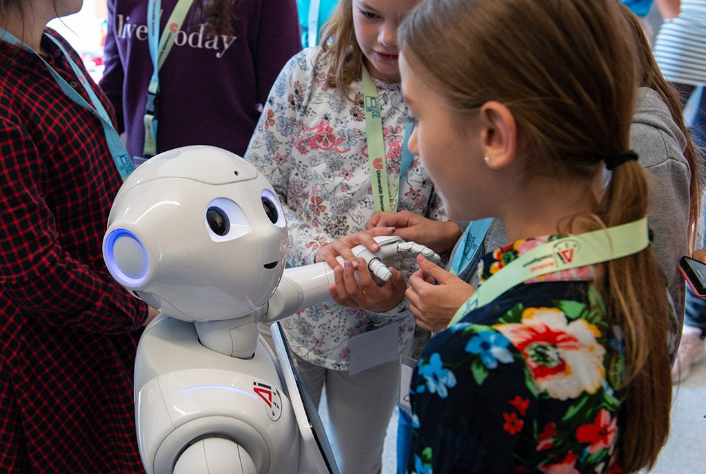 A girl interact with a humanoid robot